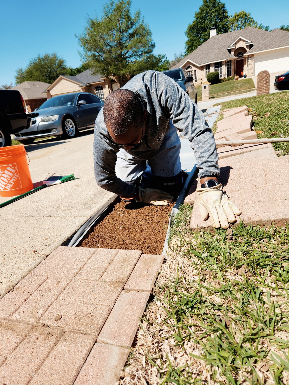 RJK Jacks of All Trades owner Kenneth Jack working on a sidewalk in front of a house